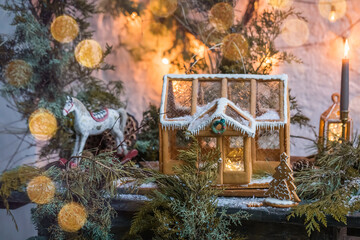 Homemade christmas ginger cottage on the wooden background, close up, selective focus