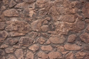 
Neatly stacked rough cut stone wall seamless texture background.