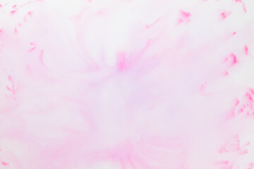Fluid art texture. White pink background from liquid. Photography of colored spots on liquid. Abstract pattern for design