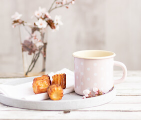 Selective focus to some pastry and cup of black coffee on plate to the wooden old table.