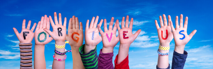Children Hands Building Colorful English Word Forgive Us. Blue Sky As Background