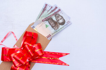 envelope containing money wrapped with an envelope on a table