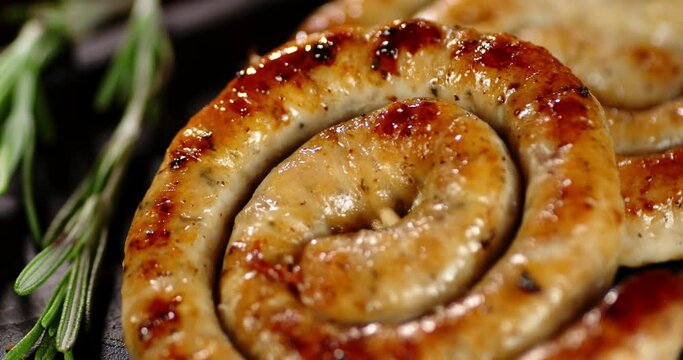 Fried sausage with rosemary slowly rotates.