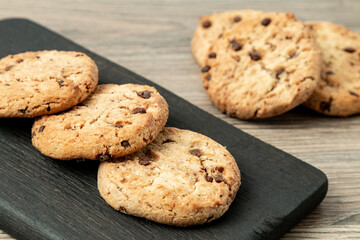 Cookies on a black wooden board on the kitchen table