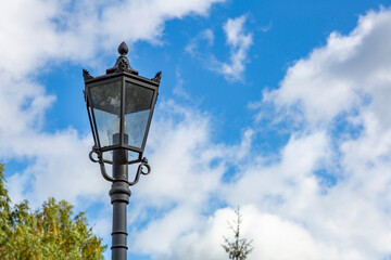 Fototapeta na wymiar Vintage black iron lantern in a public park