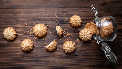 Fototapeta premium Cookies and glass jar on a wooden table