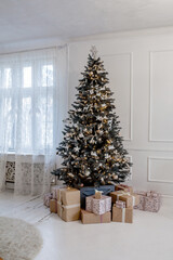 Beautifully decorated Christmas tree with many presents under it.