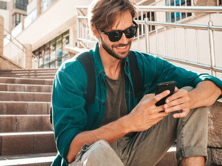 Handsome stylish smiling hipster lambersexual model.Man dressed in white T-shirt.Fashion male...