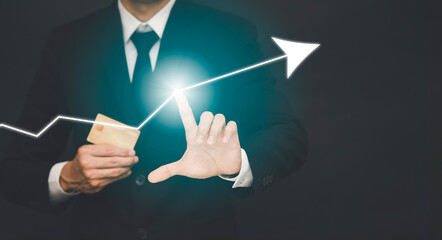 Businessman touch line arrow on the graph chart of stock market ,Technology Process System Business with Investment and stock market concept gain and profits with faded number charts.