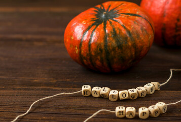 Autumn background with pumpkins on a rustic wooden background. Happy Thanksgiving with copy space. Happy Halloween text.