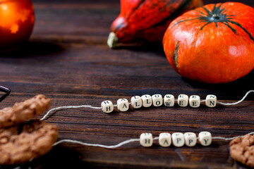 Happy Halloween text. Autumn concept with bright orange pumpkins on rustic wooden background. Happy Thanksgiving.