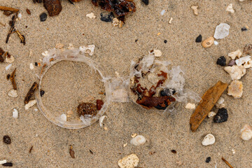 stones washed from the sea sand form beautiful patterns with a piece of green glass in the middle