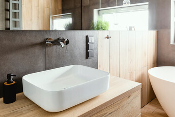 Double sinks in elegant white, concrete and wooden bathroom interior