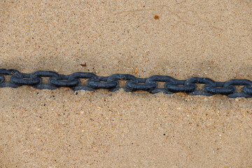 the chain stands under water in the sand