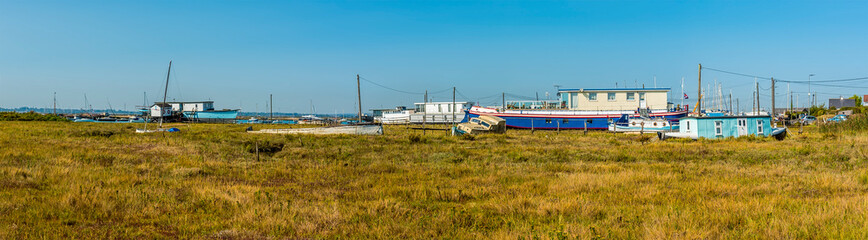 Fototapeta premium A panorama view across the salt marshes at West Mersea, UK in the summertime
