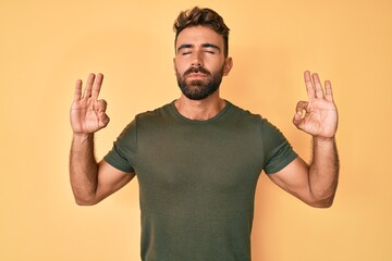 Young hispanic man wearing casual clothes relax and smiling with eyes closed doing meditation gesture with fingers. yoga concept.