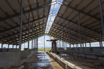 Metal frame of the building with a sandwich panel of insulation on the wall. Construction of a new industrial building. Modern Insulation of the walls of the building panels of insulation.