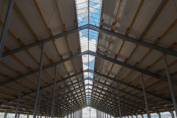 Metal frame of the building with a sandwich panel of insulation on the wall. Construction of a new industrial building. Modern Insulation of the walls of the building panels of insulation.