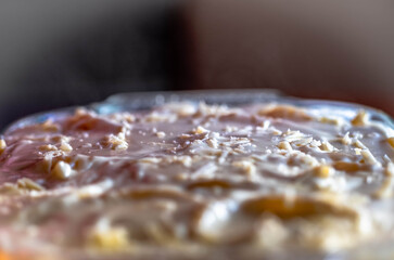 Preparing traditional greek food recipe. Baked pasta casserole pastitsio with rich bechamel sauce and ground beef.