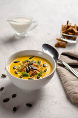 pumpkin puree soup with croutons and fried pumpkin seeds