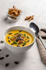 pumpkin puree soup with croutons and fried pumpkin seeds