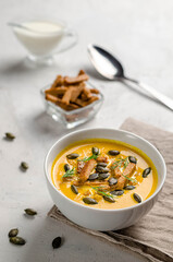 pumpkin puree soup with croutons and fried pumpkin seeds