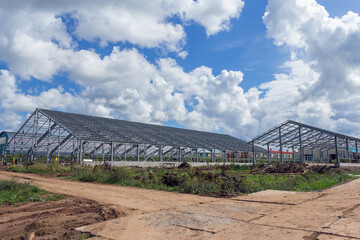 Fototapeta premium Steel frame of a building under construction. The construction of the building is made of steel beams. Construction of prefabricated structures