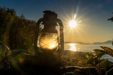 Vintage Railroad lantern lit up from the sunset