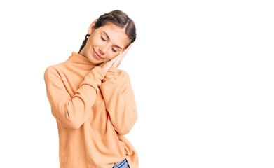 Fototapeta premium Beautiful caucasian woman with blonde hair wearing casual winter sweater sleeping tired dreaming and posing with hands together while smiling with closed eyes.