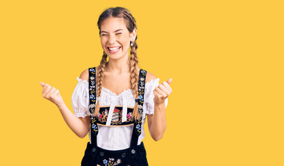 Beautiful caucasian woman with blonde hair wearing octoberfest traditional clothes very happy and...
