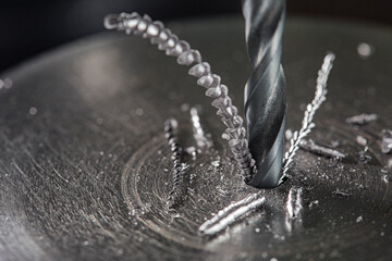 metal drill bit make holes in steel billet on industrial drilling machine. Metal work industry....