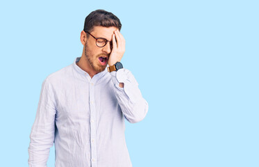 Handsome young man with bear wearing elegant business shirt and glasses yawning tired covering half face, eye and mouth with hand. face hurts in pain.