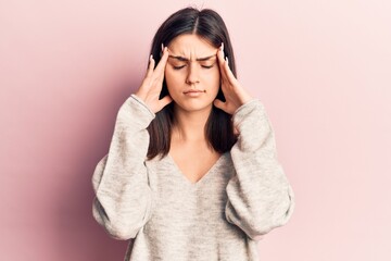 Fototapeta premium Young beautiful girl wearing casual sweater with hand on head, headache because stress. suffering migraine.