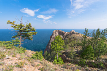 Fototapeta premium Beautiful landscape. Cape Shunte-Left or as it is called Cape of Love against the backdrop of turquoise water and blue sky. Olkhon Island, Lake Baikal. Summer travel..