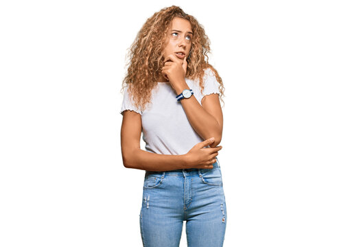 Beautiful caucasian teenager girl wearing casual white tshirt thinking worried about a question, concerned and nervous with hand on chin