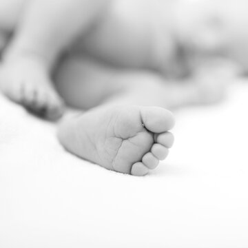 Newborn baby foot detail. Baby care. Black and white picture