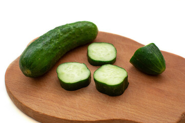 Sliced cucumber on a wooden board.
