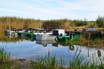 boats moored to the old wooden jetty on the lake