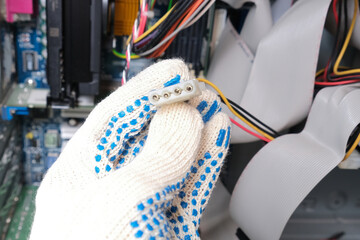 A repairer holding a cable with a connector showing a breakage of a computer, pc service and repair concept