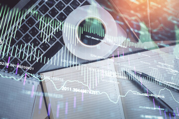 Stock market chart and top view computer on the table background. Double exposure. Concept of financial analysis.