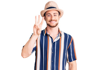 Naklejka premium Young handsome caucasian man wearing summer hat showing and pointing up with fingers number three while smiling confident and happy.