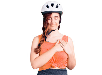Young beautiful woman wearing bike helmet smiling with hands on chest with closed eyes and grateful gesture on face. health concept.