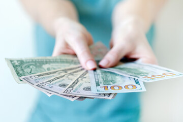 American dollars in hands. Hundred and fifty dollar bills.