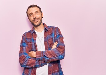 Young handsome man wearing casual clothes happy face smiling with crossed arms looking at the camera. positive person.