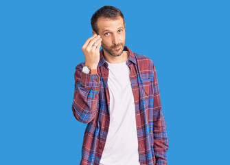 Young handsome man wearing casual clothes doing italian gesture with hand and fingers confident expression