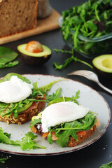 Homemade sandwiches with salmon, avocado and poached eggs