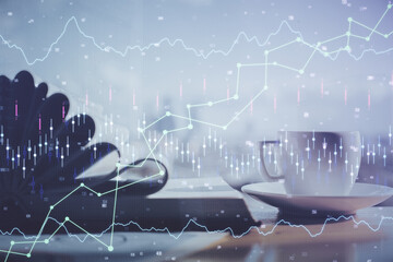 Double exposure of financial chart drawing and desktop with coffee and items on table background. Concept of forex market trading