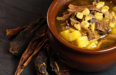 Soup with meat, potatoes, pearl barley and porcini mushrooms.