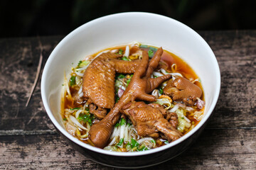 Thai street food noodles with braised chicken in a rich broth.