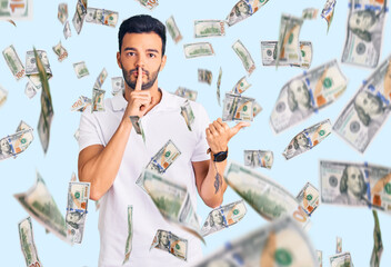 Obraz premium Young handsome hispanic man wearing casual clothes asking to be quiet with finger on lips pointing with hand to the side. silence and secret concept.